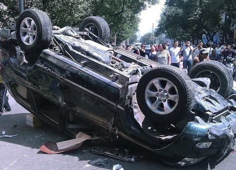 Over-turned Japanese-branded car / AP