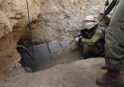 Israeli soldiers enter a tunnel discovered near the Israel Gaza border / AP