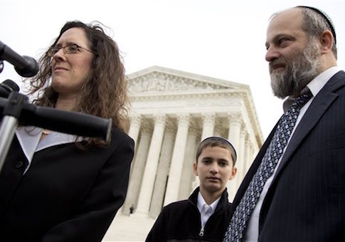 Menachem Zivotofsky, center, stands with his father Ari Zivotofsky, right, and their attorney Alyza Lewin, outside the Supreme Court in Washington, Monday, Nov. 3