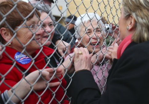Hillary Clinton greets supporters on the other side of a fence in 2008 / AP
