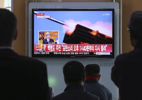 Passengers watch a television program showing reports on North Korea's plan to conduct live-fire drills, at a railway station in Seoul