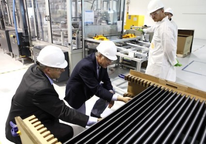 Secretary of the Interior Ken Salazar, second from left, examines solar electric panels as he tours the Abound Solar manufacturing plant
