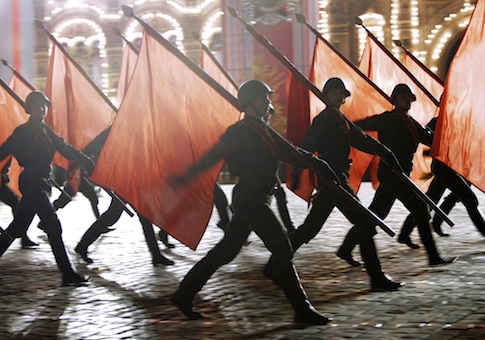 Russian soldiers with Soviet Army Red flags march during a rehearsal for the Victory Day military parade
