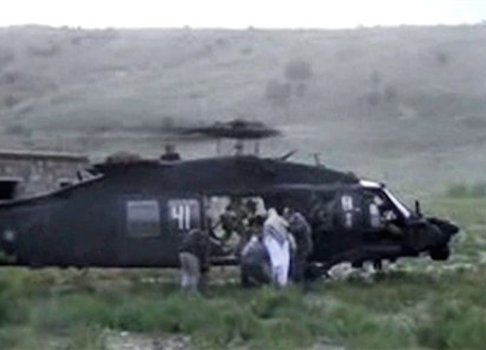A video screen capture of Bowe Bergdahl being escorted to a helicopter during his handover / AP