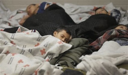 children detainees sleeping in a holding cell at a U.S. Customs and Border Protection processing facility