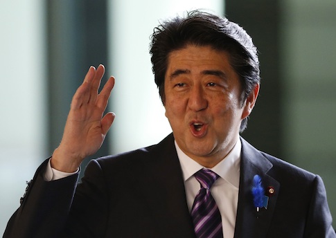 Japan's Prime Minister Shinzo Abe waves upon his arrival at his official residence in Tokyo