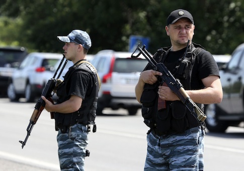 Armed pro-Russian separatists stand guard on the suburbs of Shakhtarsk, Donetsk region