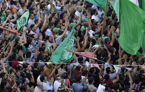 Hamas supporters shout slogans against the Israeli military action in Gaza, during a demonstration in the West Bank city of Nablus