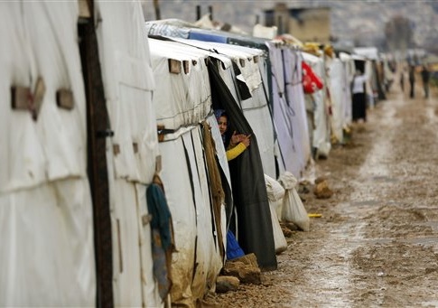 Syrian refugees gather in the Fayda Camp