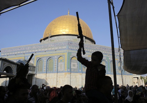 Palestinian children hold toy guns in front of the Dome of the Rock during a protest on the compound known to Muslims as al-Haram al-Sharif and to Jews as Temple Mount in Jerusalem's Old City, against Israel's military offensive in Gaza