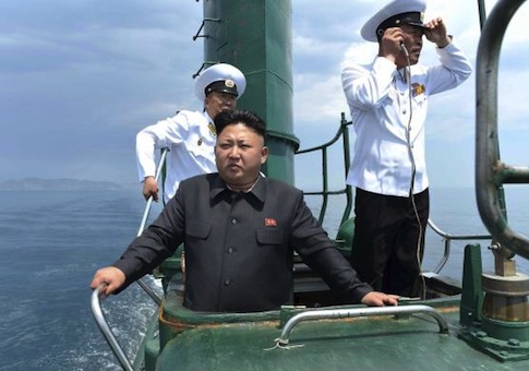 North Korean leader Kim Jong Un stands on the conning tower of a submarine during his inspection of the Korean People's Army Naval Unit 167 in this undated photo released June 16, 2014