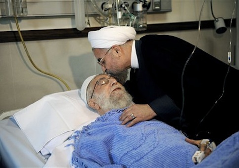 In this picture released by the official website of the office of the Iranian supreme leader, President Hassan Rouhani kisses the forehead of Supreme Leader Ayatollah Ali Khamenei after his surgery at a hospital in Tehran, Iran