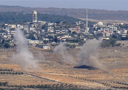Smoke rises following explosions in Syria, seen from the Israeli-controlled Golan Heights, Tuesday, Sept. 23, 2014. The Israeli military said it shot down a Syrian fighter jet using the Patriot air defense system after the plane infiltrated airspace over the Golan Heights early Tuesday