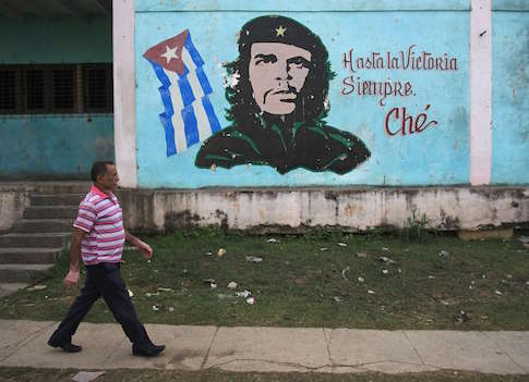 A man walks past near an image of revolutionary hero Ernesto "Che" Guevara in Havana December 27, 2014
