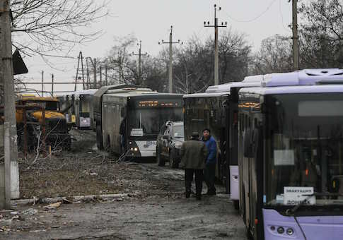 Empty buses, intended for internally displaced persons (IDPs), wait along a road while travelling in the direction of the village of Debaltseve to evacuate the residents, in Vuhlehirsk, Donetsk region February 6, 2015