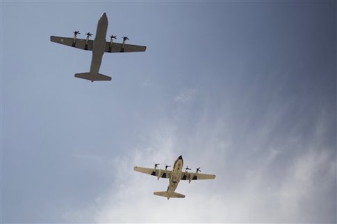 The C-130J Super Hercules military aircraft , left, and an Israeli air force C-130 about to land during an unveiling ceremony upon its arrival in Nevatim Air Force base near Beersheba , Southern Israel, Wednesday, April 9, 2014