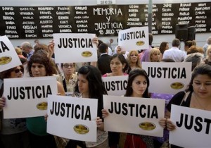 People gather outside the AMIA Jewish community center asking for "Justice" in the death of a prosecutor who had accused Argentinaís president of a criminal conspiracy, in Buenos Aires, Argentina, Wednesday, Jan. 21