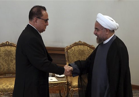 Iranian President Hassan Rouhani, right, welcomes North Korean Foreign Minister Ri Su Yong, for a meeting in Tehran, Iran, Tuesday, Sept. 16, 2014