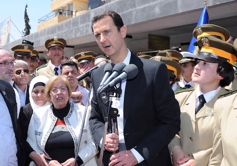 President Bashar al-Assad addresses his supporters at a school in an undisclosed location during an event to commemorate Syria's Martyrs' Day