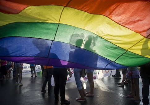Members of the LGBT movement hold a gay pride flag as they attend a march to mark the International Day Against Homophobia in Managua, Nicaragua