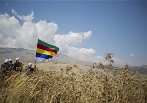 In this photo taken on Tuesday, June 16, 2015, members of the Druze minority walk in Israeli-controlled Golan Heights as the fighting between forces loyal to Syrian President Bashar Assad and rebels in Druze village of Khader in Syria continues