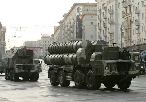 Russian military vehicles move along a central street during a rehearsal for a military parade in Moscow