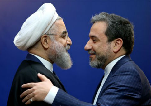 Iran’s Deputy Foreign  Minister Abbas Araghchi, right, embraces President Hassan Rouhani / AP
