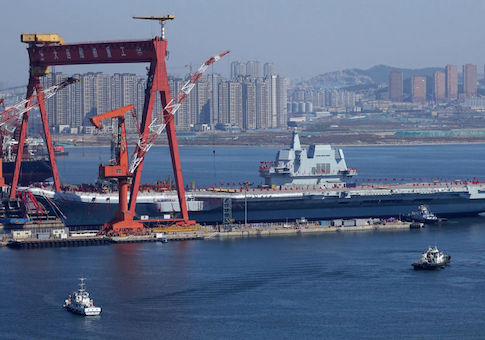 China's homegrown aircraft carrier is transferred from the dry dock into the water during a launch ceremony at Dalian shipyard