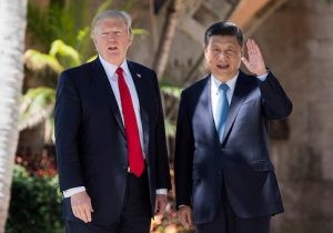 Chinese President Xi Jinping waves to the press as he walks with US President Donald Trump at the Mar-a-Lago estate in West Palm Beach, Florida