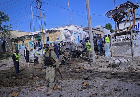 Somali soldiers attend the scene of a suicide car bomb attack linked to al Qaeda