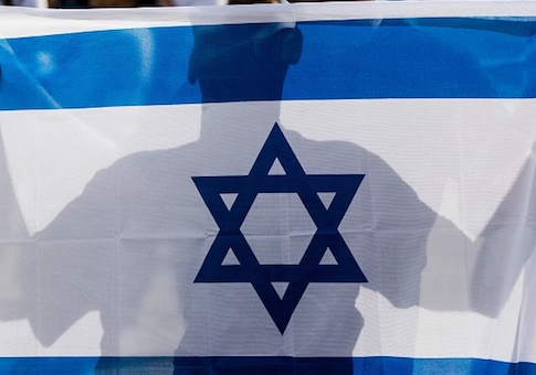 An Israeli man holds his country's national flag