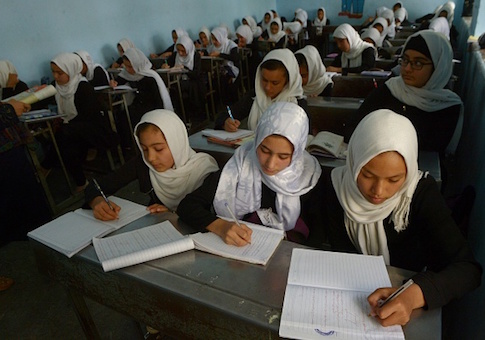 Afghan girls study during a lesson at a school in Herat province
