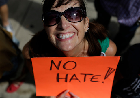 A demonstrator holds a sign during a protest against hate