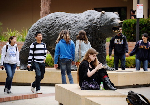 Students sit around the Bruin Bear statue during lunchtime on the campus of UCLA