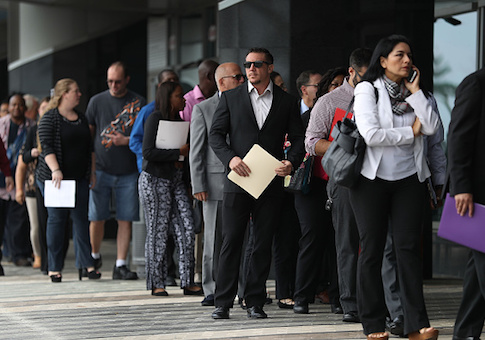 People stand in line as they wait to get into the JobNewsUSA job fair