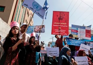 UNRWA staff take part in a protest in front of the agency's headquarters in Gaza City