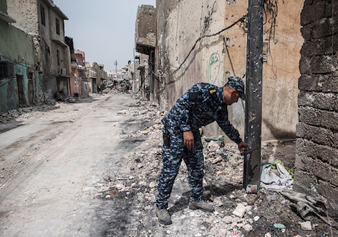 An Iraqi federal police captain points towards an unexploded IED left by ISIS