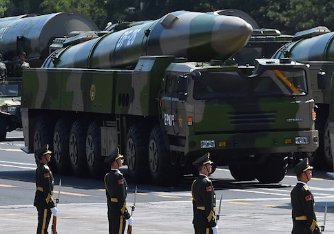 Military vehicles carrying DF-26 ballistic missiles participate in a military parade