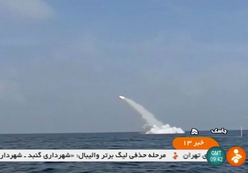 An Iranian cruise missile fires into the air from a submarine during a test at Strait of Hormuz