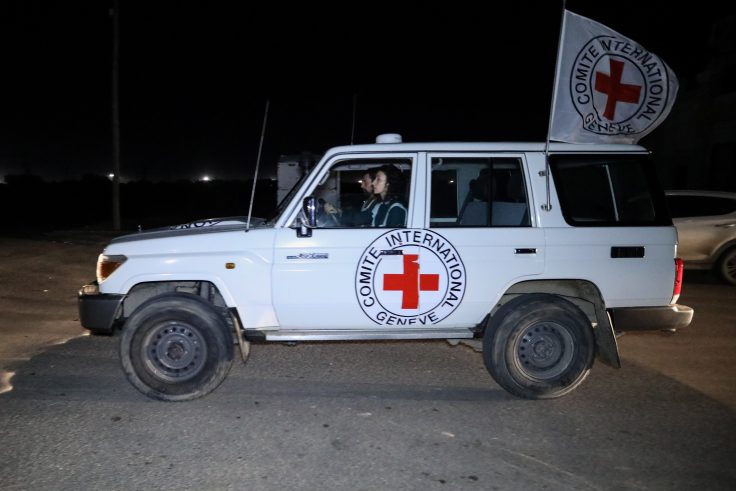 RAFAH, GAZA - NOVEMBER 30: Hostages are transported in International Committee of the Red Cross vehicles from the Gaza Strip through the Rafah land crossing on November 30, 2023 in Rafah, Gaza. Israel and Hamas agreed to a further extension to a truce that has lasted nearly a week, which promised the release of more Israeli hostages held in Gaza, as well as the release of Palestinian prisoners held in Israeli jails.